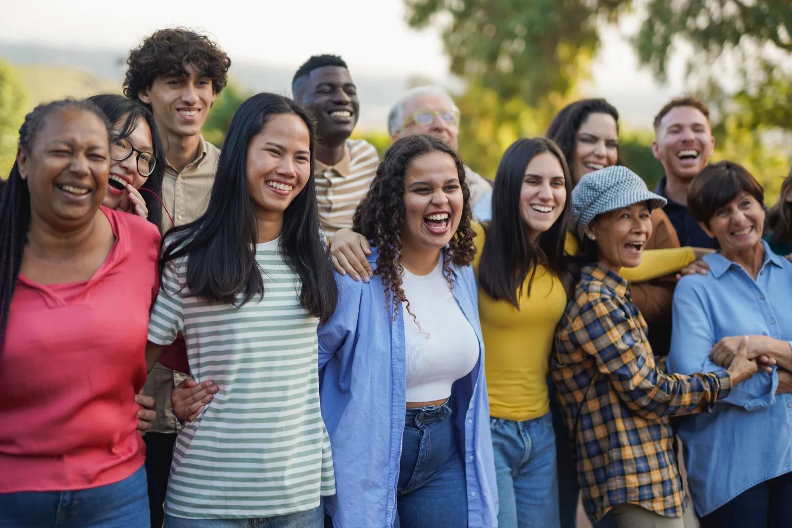 Partner organization staff and families together, laughing and connecting outdoors